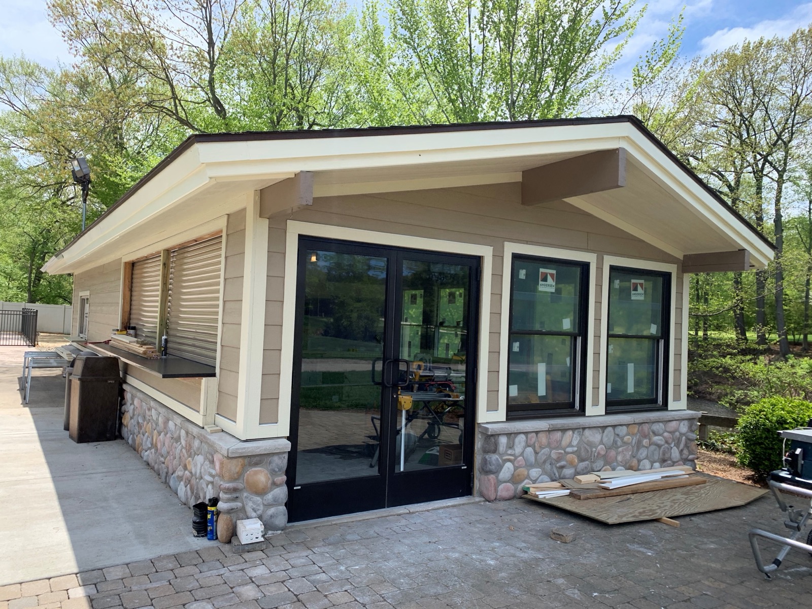Completed building with glass doors and a stone exterior