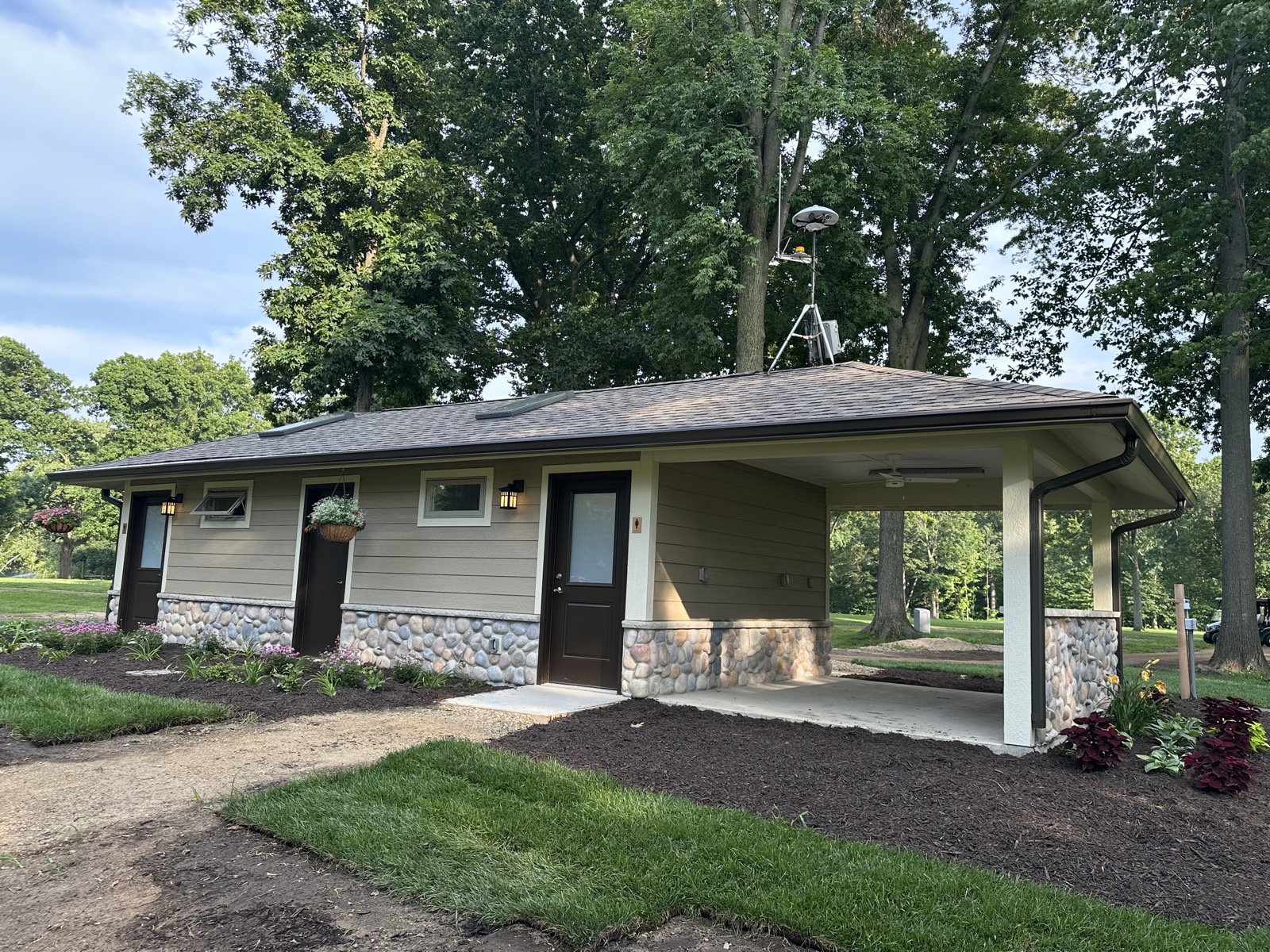 Completed building exterior with lawn and trees