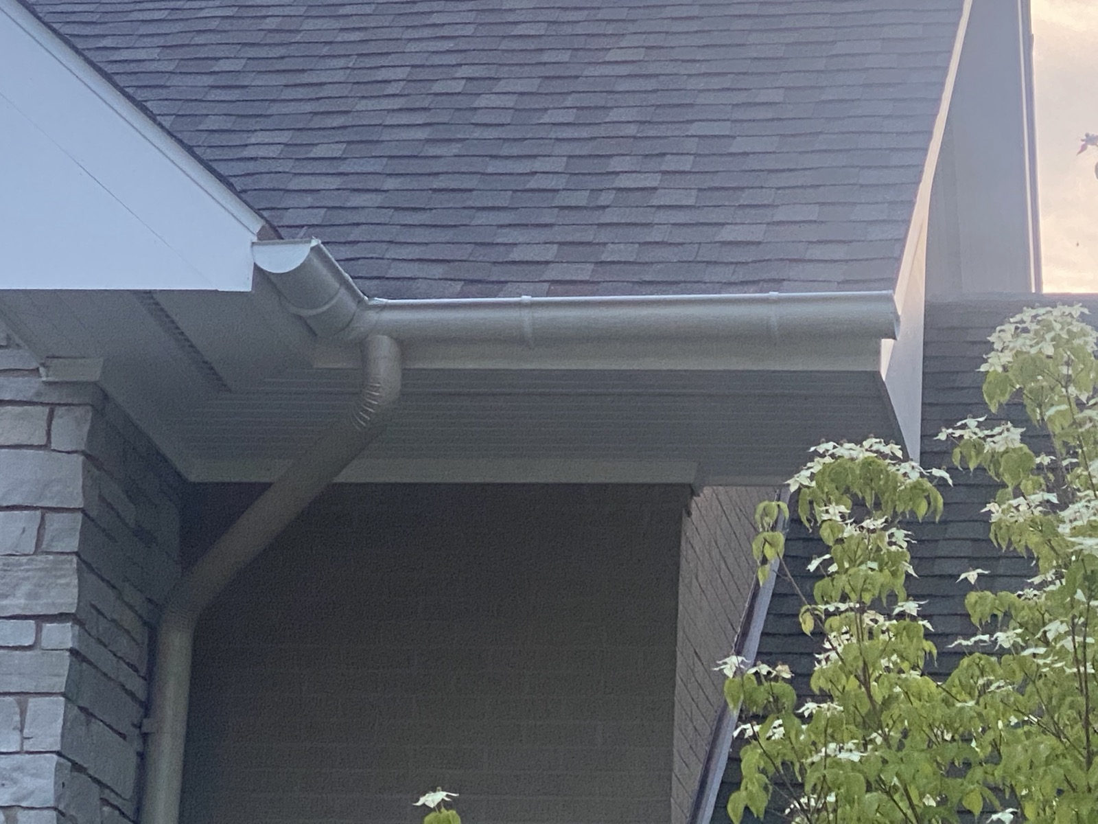 Gutter and downspout at the corner of a home